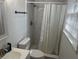 Clean bathroom featuring white tile in the shower, white walls and fixtures, and a window for natural light at 1866 Ashley Hall Rd, Charleston, SC 29407