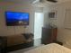 Comfortable bedroom with mounted TV, dark wood floors, and a neutral color scheme for a relaxing atmosphere at 1866 Ashley Hall Rd, Charleston, SC 29407