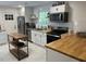 Updated kitchen featuring white cabinets, butcher block counters, and stainless steel appliances at 1866 Ashley Hall Rd, Charleston, SC 29407