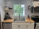Bright kitchen featuring a stainless sink, subway tile backsplash, and window overlooking lush greenery at 1866 Ashley Hall Rd, Charleston, SC 29407