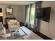 Bright living room featuring stylish decor, a glass coffee table, and a mounted TV at 1866 Ashley Hall Rd, Charleston, SC 29407