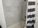 Tiled shower area, complemented by a bathtub and striped curtain for a sleek and modern bathroom design at 1866 Ashley Hall Rd, Charleston, SC 29407