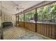 Cozy screened-in back porch with a ceiling fan and decorative lattice paneling overlooking the backyard at 195 Edinburgh St, Summerville, SC 29483