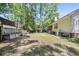 The spacious backyard features raised garden beds and leads up to the home and screened-in porch at 195 Edinburgh St, Summerville, SC 29483