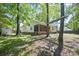 Spacious backyard featuring mature trees, a custom playset, and views of the home's screened porch at 195 Edinburgh St, Summerville, SC 29483