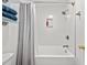 Renovated bathroom features a shower and tub combination with bright white tiles and modern fixtures at 195 Edinburgh St, Summerville, SC 29483