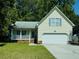 Charming one-story home with a two-car garage, inviting porch, and well-maintained lawn at 195 Edinburgh St, Summerville, SC 29483