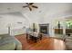 Spacious living room with a fireplace, vaulted ceiling, hardwood floors, and a ceiling fan at 195 Edinburgh St, Summerville, SC 29483