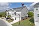 Aerial view of a two-story townhouse with a front-facing garage and manicured landscaping at 207 Winding River Dr, Johns Island, SC 29455