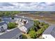 Scenic aerial shot showcasing a neighborhood bordered by lush greenery, waterfront, and picturesque waterways at 207 Winding River Dr, Johns Island, SC 29455