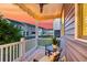 A tranquil back porch with outdoor seating, wooden deck, fan, and view of the community at 207 Winding River Dr, Johns Island, SC 29455