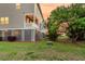 Spacious backyard with a covered porch, lush greenery, and natural surroundings at 207 Winding River Dr, Johns Island, SC 29455