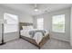 Bright bedroom with a wood bedframe, blanket, ceiling fan and natural light from two large windows at 207 Winding River Dr, Johns Island, SC 29455