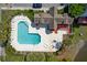 Aerial view of a community pool and clubhouse area with seating, landscaping, and mature trees at 207 Winding River Dr, Johns Island, SC 29455
