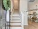 Inviting entryway with wood stairs and hardwood floors that lead to an open-concept living and dining area at 207 Winding River Dr, Johns Island, SC 29455