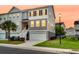 Charming townhome with a two-car garage, manicured lawn, and inviting staircase leading to the front entrance at 207 Winding River Dr, Johns Island, SC 29455