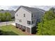 Exterior aerial view of a well-maintained townhome with lush landscaping and a private porch at 207 Winding River Dr, Johns Island, SC 29455