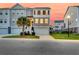 Stylish townhouse features a garage, charming palm tree, and well-maintained lawn, set against a vivid pink sky at 207 Winding River Dr, Johns Island, SC 29455