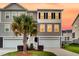 Home exterior featuring a well-manicured lawn and tropical palm trees at sunset at 207 Winding River Dr, Johns Island, SC 29455