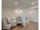 Hallway with hardwood floors, two upholstered chairs, table with lamp, and overhead lights at 207 Winding River Dr, Johns Island, SC 29455