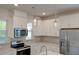 Contemporary kitchen with white cabinetry, stainless steel appliances, and elegant pendant lighting at 207 Winding River Dr, Johns Island, SC 29455