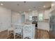 Bright kitchen with white cabinets, quartz countertops, a stylish island, and modern appliances at 207 Winding River Dr, Johns Island, SC 29455