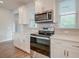 Modern kitchen with white cabinets, stainless steel appliances, and quartz countertops at 207 Winding River Dr, Johns Island, SC 29455