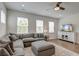 Cozy living room featuring a sectional sofa, plush ottoman, and a TV, perfect for relaxation and entertainment at 207 Winding River Dr, Johns Island, SC 29455