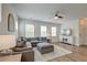 Bright living room featuring a comfortable gray sectional sofa, stylish rug, and large windows at 207 Winding River Dr, Johns Island, SC 29455
