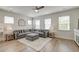 Well-lit living room features a gray sectional sofa, decorative rug, and modern ceiling fan at 207 Winding River Dr, Johns Island, SC 29455