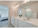Ensuite bath featuring double sinks, bright lighting, a glass-enclosed shower, and views into the bedroom at 207 Winding River Dr, Johns Island, SC 29455