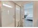 Ensuite bath featuring glass enclosed shower with a bench and views into the main bedroom at 207 Winding River Dr, Johns Island, SC 29455