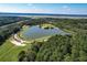 Aerial view of the lake and park featuring a paved walkway and lush trees surrounding it at 2131 Pentland Dr, Charleston, SC 29412