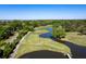 An aerial view of a scenic golf course with a beautiful blue lake and lush green trees along the edge at 2131 Pentland Dr, Charleston, SC 29412