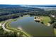 Aerial view of a community lake and park featuring a paved trail and lush trees around it at 2131 Pentland Dr, Charleston, SC 29412