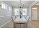 Dining room with neutral tones, natural light, and a contemporary chandelier above a dining table at 2131 Pentland Dr, Charleston, SC 29412