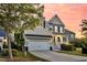 Beautiful home showcasing its front exterior with a large garage and inviting front porch at 2131 Pentland Dr, Charleston, SC 29412