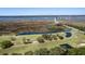 Scenic aerial of the golf course with marshes, a bridge to the community, and ponds, illustrating an active lifestyle and waterside views at 2131 Pentland Dr, Charleston, SC 29412