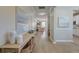 Elegant hallway with light hardwood floors, decorative vases, and artwork leading to living areas at 2131 Pentland Dr, Charleston, SC 29412