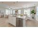 Open concept kitchen with island, stainless steel appliances, and views into the dining and living rooms at 2131 Pentland Dr, Charleston, SC 29412