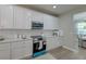 Contemporary kitchen featuring white subway tile backsplash, quartz countertops, and stainless appliances at 2131 Pentland Dr, Charleston, SC 29412