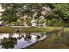 Pond view with mature trees reflecting in the water and providing a sense of tranquility at 2131 Pentland Dr, Charleston, SC 29412