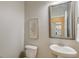 Bright powder room featuring a pedestal sink, decorative mirror, and framed floral art at 2131 Pentland Dr, Charleston, SC 29412