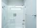 Bright bathroom features tub/shower with glass doors, shower niche, white subway tile and chrome fixtures at 2130 Weaver St, Charleston, SC 29403