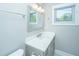 Bright bathroom features vanity with brushed nickel faucet, large mirror, decorative light fixture, and window at 2130 Weaver St, Charleston, SC 29403