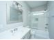 Bright bathroom features vanity, tub/shower with glass doors, white subway tile and decorative light fixture at 2130 Weaver St, Charleston, SC 29403