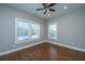 Bright bedroom features hardwood floors, three windows, fresh neutral paint and ceiling fan at 2130 Weaver St, Charleston, SC 29403