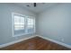 A bedroom with hardwood floors and a window is ready to be turned into your cozy sanctuary at 2130 Weaver St, Charleston, SC 29403