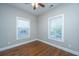 Bright bedroom features hardwood floors, two windows and fresh neutral paint at 2130 Weaver St, Charleston, SC 29403