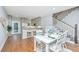 Open concept dining area with a view of the kitchen and stairs leading to the second floor at 2130 Weaver St, Charleston, SC 29403